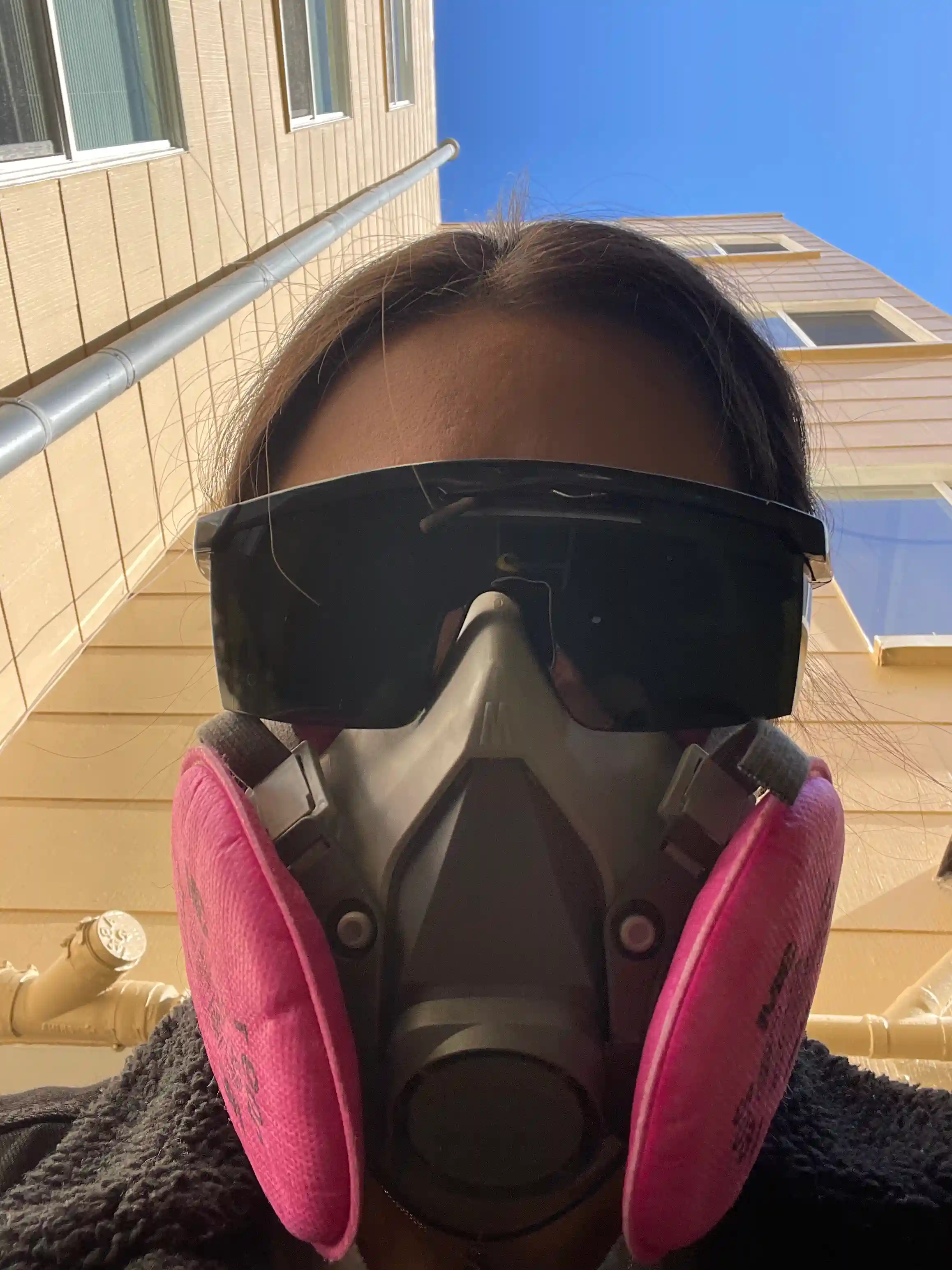 Wearing safety glasses and a respirator for backyard metalwork